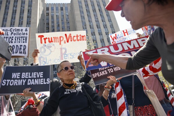 A protestor demonstrates against Donald Trump amidst Trump supporters outside Manhattan criminal court, Monday, April 15, 2024, in New York. (AP Photo/Stefan Jeremiah)